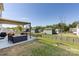 A backyard features a covered patio with outdoor seating and a grill, perfect for entertaining at 325 Crandon Rd, Mount Holly, NC 28120