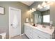 Bathroom featuring double sinks, white cabinetry, and a large mirror at 325 Crandon Rd, Mount Holly, NC 28120