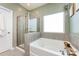 A modern bathroom showcasing a soaking tub and separate glass-enclosed shower at 325 Crandon Rd, Mount Holly, NC 28120