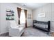 Bedroom showcasing a comfortable chair and modern black crib, perfect for a growing Gathering at 325 Crandon Rd, Mount Holly, NC 28120
