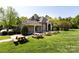 The clubhouse features stone accents, outdoor picnic tables, and landscaped grounds at 325 Crandon Rd, Mount Holly, NC 28120