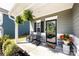 Inviting front porch with rocking chairs, potted plants, and a decorative wreath on the front door at 325 Crandon Rd, Mount Holly, NC 28120