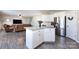 Bright kitchen island boasts granite counters, white cabinetry, and an open view to the living area at 325 Crandon Rd, Mount Holly, NC 28120