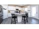 Stylish kitchen island featuring a granite countertop, seating, and white cabinets, open to the rest of kitchen at 325 Crandon Rd, Mount Holly, NC 28120