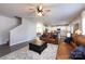 View of the living space open to the kitchen area and stairs with natural lighting at 325 Crandon Rd, Mount Holly, NC 28120