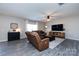 Living room features neutral decor, wood-look floors, media center, and large windows at 325 Crandon Rd, Mount Holly, NC 28120