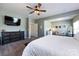 Cozy main bedroom features soft colors, a ceiling fan, and a seating area at 325 Crandon Rd, Mount Holly, NC 28120
