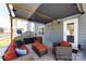A covered patio boasts cozy outdoor seating, creating a relaxing entertainment space at 325 Crandon Rd, Mount Holly, NC 28120