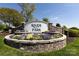 A stone sign for River Park is surrounded by colorful flowers in a landscaped display at 325 Crandon Rd, Mount Holly, NC 28120