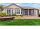 Well-maintained backyard with a screened-in porch, stone patio, and flower garden at 331 Miners Cove Way, Fort Mill, SC 29708