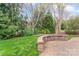 Landscaped backyard with a stone seating area, perfect for enjoying the outdoors at 331 Miners Cove Way, Fort Mill, SC 29708