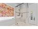 Glass-enclosed shower with bench and neutral tile at 331 Miners Cove Way, Fort Mill, SC 29708