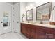 Bathroom featuring dual sinks with granite countertop and framed mirrors at 331 Miners Cove Way, Fort Mill, SC 29708