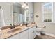 This bathroom features dual sinks with a large mirror and a window offering natural light at 331 Miners Cove Way, Fort Mill, SC 29708
