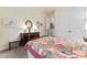 Bright bedroom featuring a decorative bed with colorful quilt, wooden furniture and tasteful wall décor at 331 Miners Cove Way, Fort Mill, SC 29708