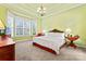 This bedroom features beautiful natural light from the large bay window and a decorative chandelier at 331 Miners Cove Way, Fort Mill, SC 29708