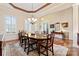 The dining room features a chandelier, window with shutters, and a table with seating for six at 331 Miners Cove Way, Fort Mill, SC 29708