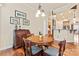 Inviting dining room with wooden table, upholstered chairs, and views of the kitchen and decor at 331 Miners Cove Way, Fort Mill, SC 29708