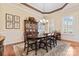 This dining room offers a large dining table with seating for six, chandelier, and elegant décor at 331 Miners Cove Way, Fort Mill, SC 29708