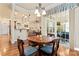 Cozy dining room with a round wooden table, elegant chandelier, and access to the patio at 331 Miners Cove Way, Fort Mill, SC 29708