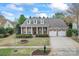 Beautiful brick home with a three-car garage, well-manicured lawn, and charming curb appeal at 331 Miners Cove Way, Fort Mill, SC 29708