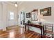 Foyer featuring hardwood floors, a decorative door and sidelights, and a console table with decor at 331 Miners Cove Way, Fort Mill, SC 29708