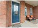 Inviting front entrance showcasing a blue door with decorative glass, sidelights, and outdoor seating area at 331 Miners Cove Way, Fort Mill, SC 29708