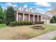 Charming brick home featuring a manicured front yard with classic white-columned porch and attached two car garage at 331 Miners Cove Way, Fort Mill, SC 29708