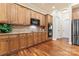 Well-lit kitchen features granite countertops, wooden cabinets, tile backsplash and stainless steel appliances at 331 Miners Cove Way, Fort Mill, SC 29708