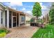 Paver patio with awning, screened-in porch, and outdoor kitchen area at 331 Miners Cove Way, Fort Mill, SC 29708
