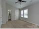 Bright bedroom features neutral walls, ceiling fan, and double window offering lots of natural light at 3835 Mohawk Ct, Charlotte, NC 28215