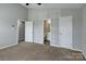 This is a view of the bedroom showing doors to the bathroom, closet, and hallway at 3835 Mohawk Ct, Charlotte, NC 28215