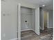 Spacious closet featuring shelving, rod, open doors, and access to mechanicals and laundry hook-ups at 3835 Mohawk Ct, Charlotte, NC 28215