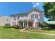 Charming two-story home featuring eye-catching red shutters and lush green landscaping at 3835 Mohawk Ct, Charlotte, NC 28215