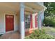 Inviting front porch with red door, white columns, and well-maintained landscaping at 3835 Mohawk Ct, Charlotte, NC 28215
