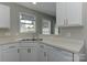 Kitchen area with stainless steel sink, bright window, white cabinets, and laminate countertops at 3835 Mohawk Ct, Charlotte, NC 28215