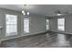 Bright living room featuring sleek wood floors, neutral paint, modern lighting and multiple windows at 3835 Mohawk Ct, Charlotte, NC 28215