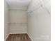 Walk-in closet with carpeted floor and multiple white metal shelves at 3835 Mohawk Ct, Charlotte, NC 28215