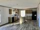 Open kitchen with an island, sleek appliances, and hardwood floors at 3925 Taylorsville Hwy, Statesville, NC 28625