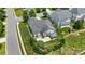 An aerial view of a property with a gray roof, fenced backyard, patio area, and landscaped surroundings at 4006 Fall Oak Ter, Fort Mill, SC 29707