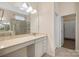 Bright bathroom featuring a marble vanity, glass shower, and doorway to closet space at 4006 Fall Oak Ter, Fort Mill, SC 29707
