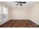 Spacious bedroom with hardwood floors, ceiling fan, and large windows providing natural light at 4006 Fall Oak Ter, Fort Mill, SC 29707