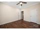 Bedroom featuring hardwood floors, a ceiling fan and adjacent access to a closet and ensuite at 4006 Fall Oak Ter, Fort Mill, SC 29707