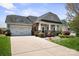 Charming single-Gathering home with a welcoming front porch, manicured lawn, and attached two-car garage at 4006 Fall Oak Ter, Fort Mill, SC 29707