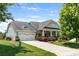 Charming home featuring a well-manicured lawn, a two-car garage, and a welcoming front porch at 4006 Fall Oak Ter, Fort Mill, SC 29707