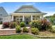 Inviting front exterior showcasing a landscaped yard and a covered porch with ceiling fans at 4006 Fall Oak Ter, Fort Mill, SC 29707
