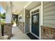 Close-up of the covered front porch featuring brick accents and stylish front door at 4006 Fall Oak Ter, Fort Mill, SC 29707