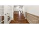 Hallway showcasing hardwood floors and architectural details leading to an open living space at 4006 Fall Oak Ter, Fort Mill, SC 29707