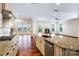 Gourmet kitchen featuring stainless appliances, gas cooktop, granite countertops, and an open floorplan at 4006 Fall Oak Ter, Fort Mill, SC 29707