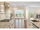 An open-concept kitchen boasts granite countertops, stainless steel appliances, and hardwood floors at 4006 Fall Oak Ter, Fort Mill, SC 29707